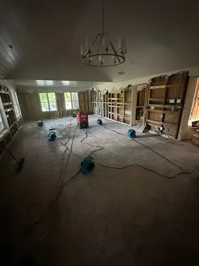 Air movers running in a dark, emptied room while a Federal Heights home is dried after a water loss